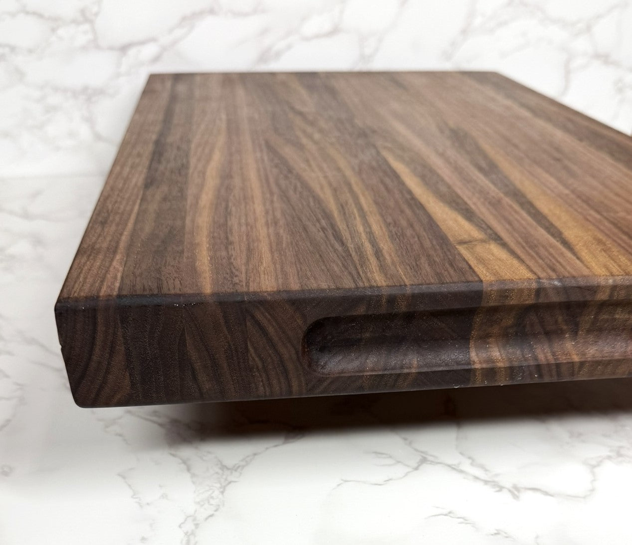 "Premium Black Walnut Edge Grain Cutting Board showcasing rich wood grain and craftsmanship"
