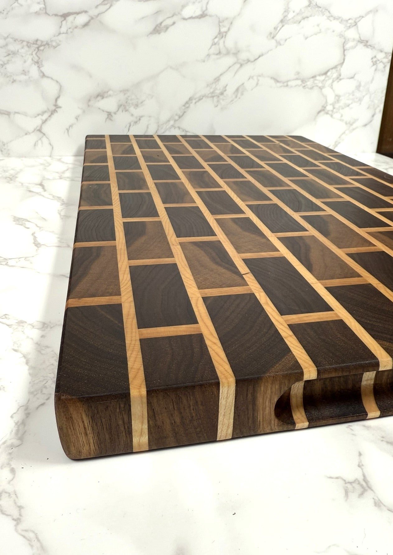 Brick & Mortar end grain cutting board showcasing Black Walnut and Maple pattern"