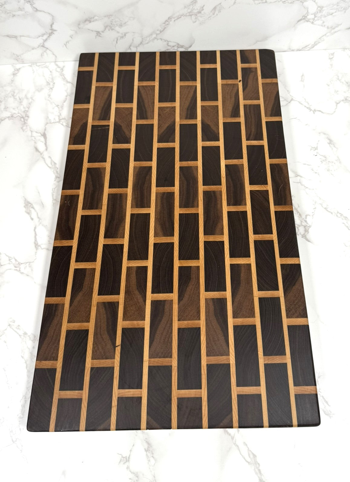 Brick & Mortar end grain cutting board showcasing Black Walnut and Maple pattern"