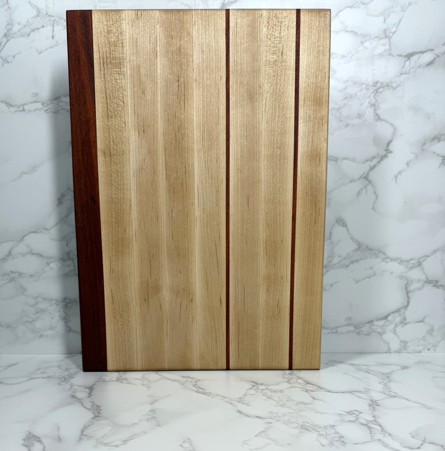 Maple, with thin stripe of Padauk Edge Grain Cutting board 14x10x1.25"