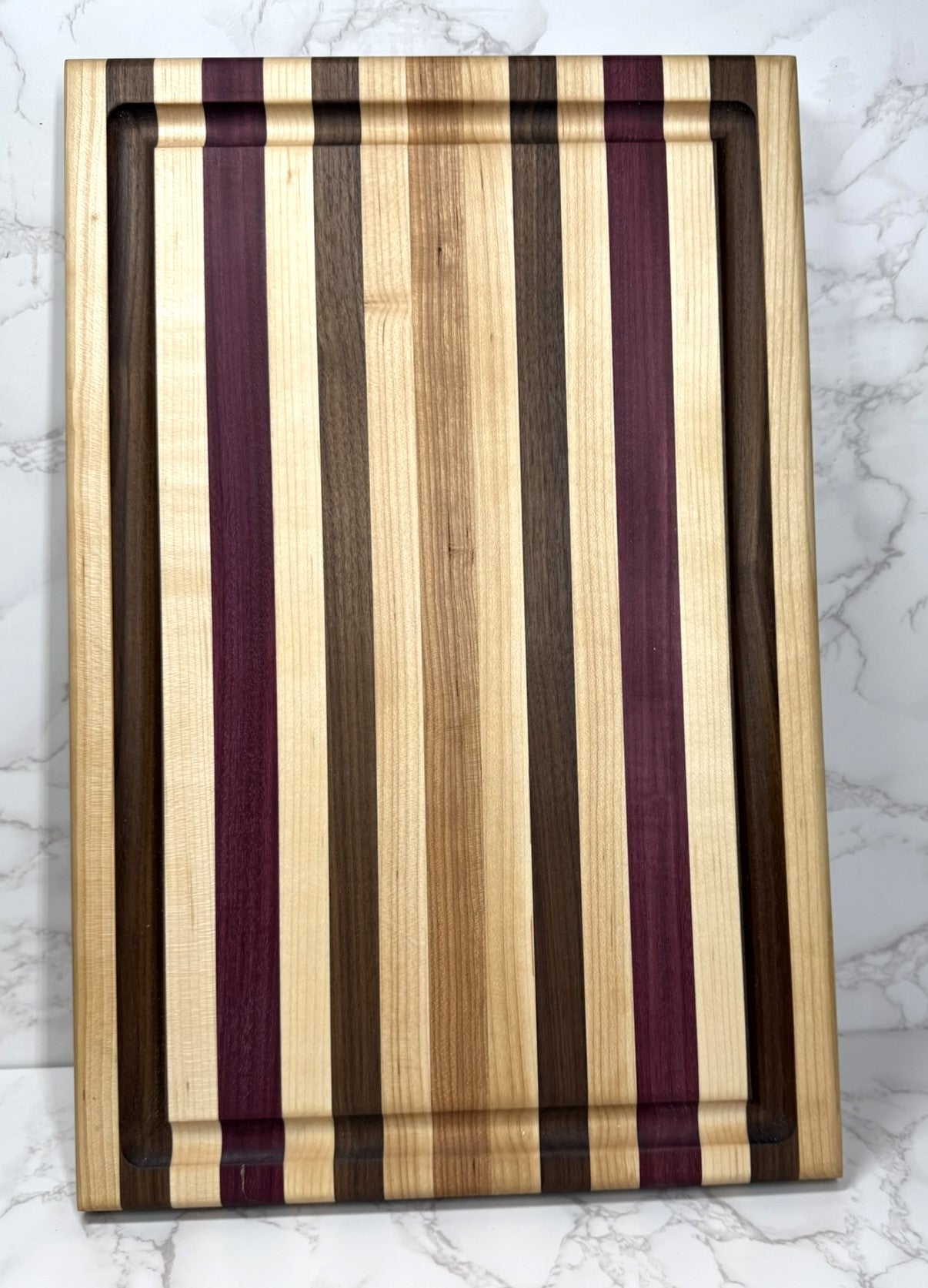 "Light Stripe Edge Grain Cutting Board showcasing Walnut, Maple, Cherry, and Purpleheart woods"