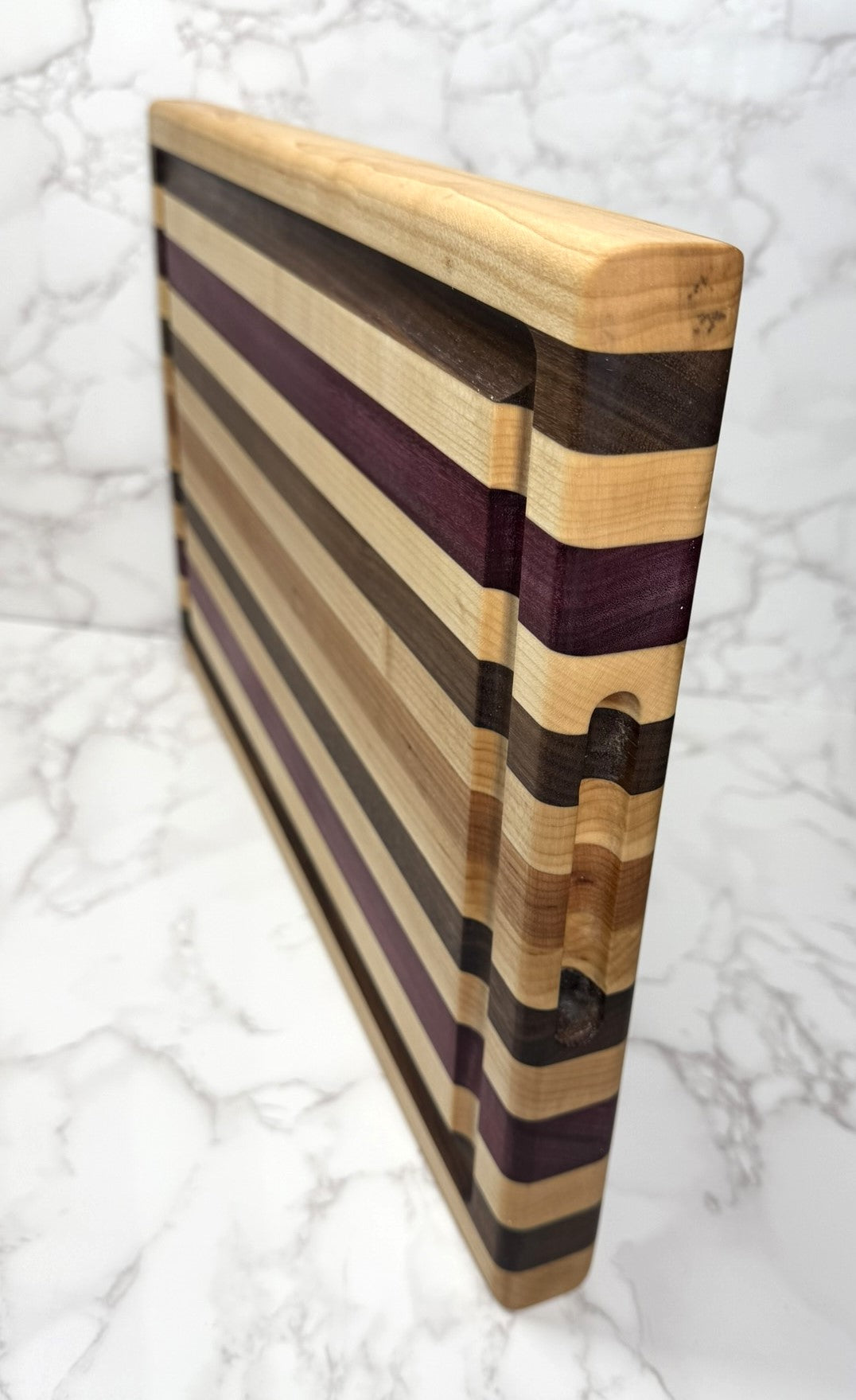 "Light Stripe Edge Grain Cutting Board showcasing Walnut, Maple, Cherry, and Purpleheart woods"