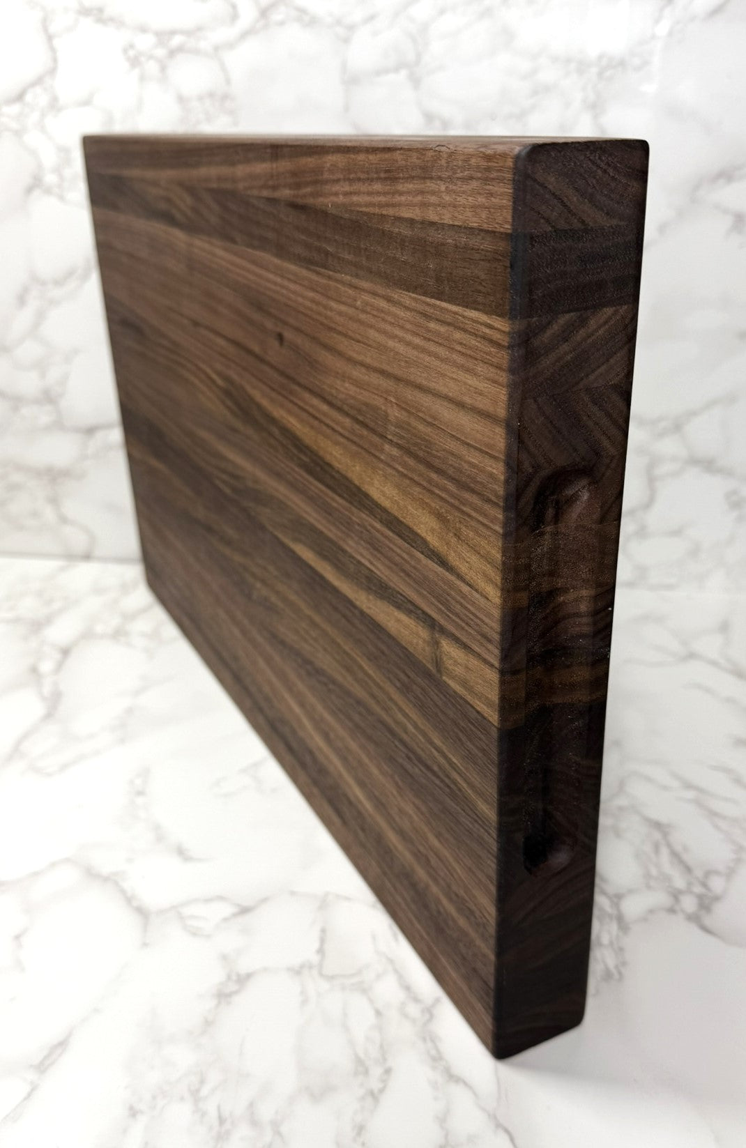 "Premium Black Walnut Edge Grain Cutting Board showcasing rich wood grain and craftsmanship"