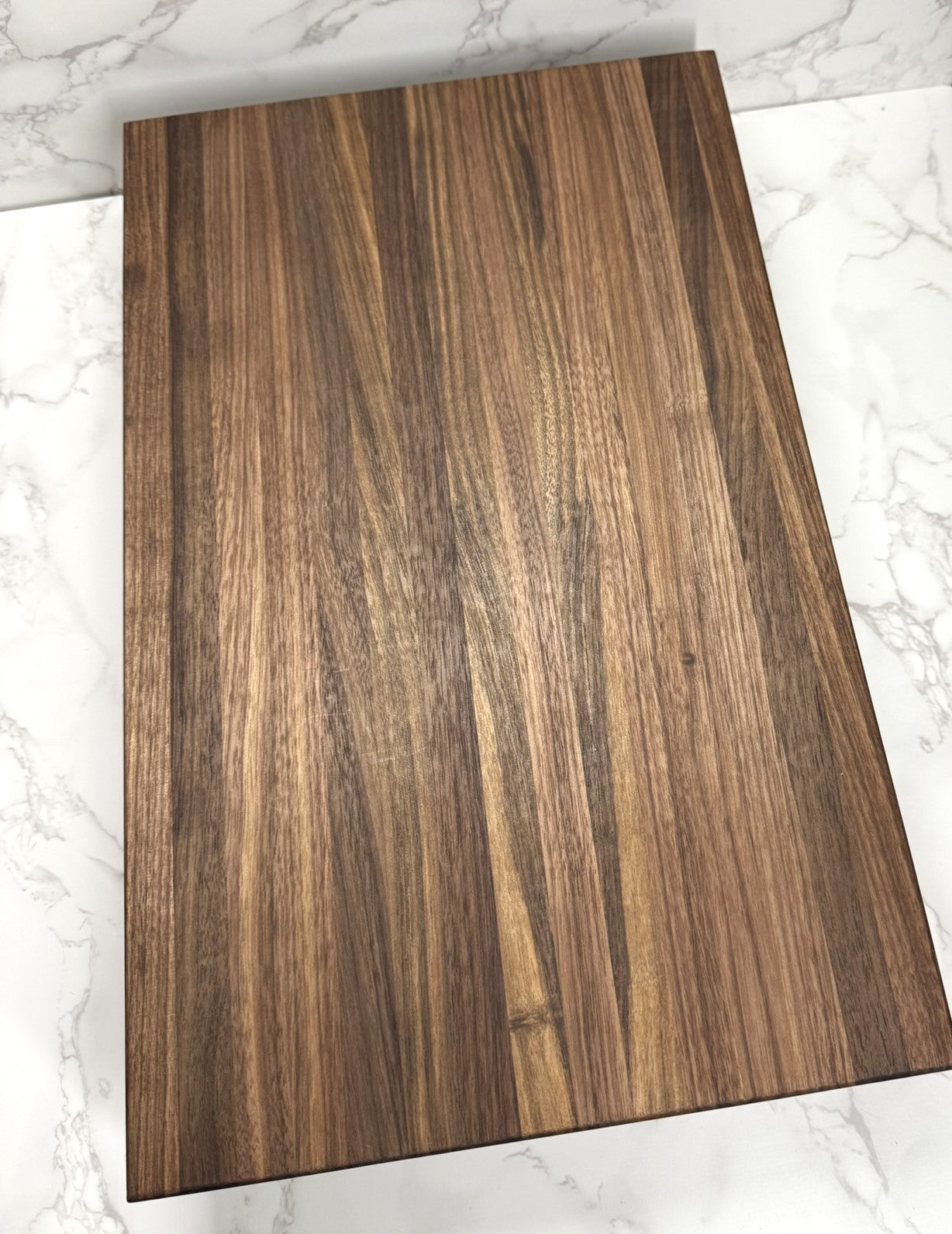 "Premium Black Walnut Edge Grain Cutting Board showcasing rich wood grain and craftsmanship"